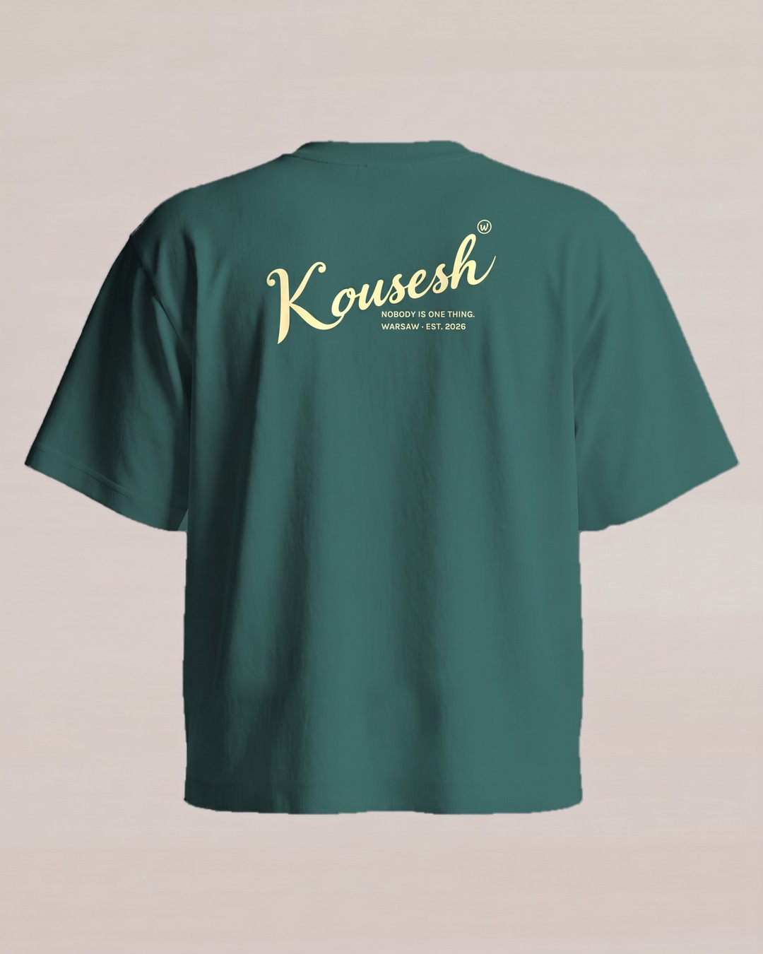 Green tee, back, with Kousesh in script set at an angle and two small lines of text underneath
